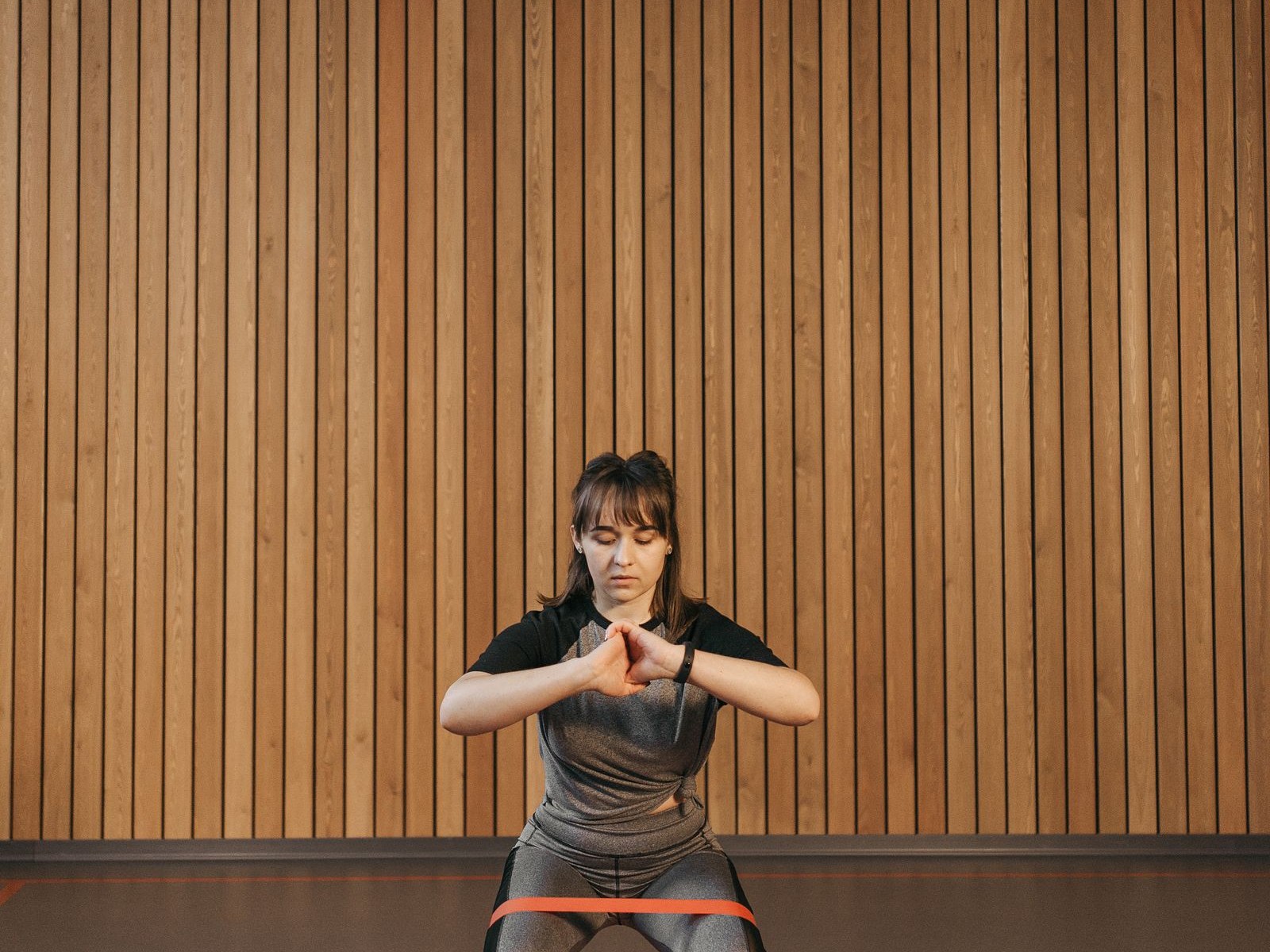 Sportive réalisant un squat avec un élastique de résistance